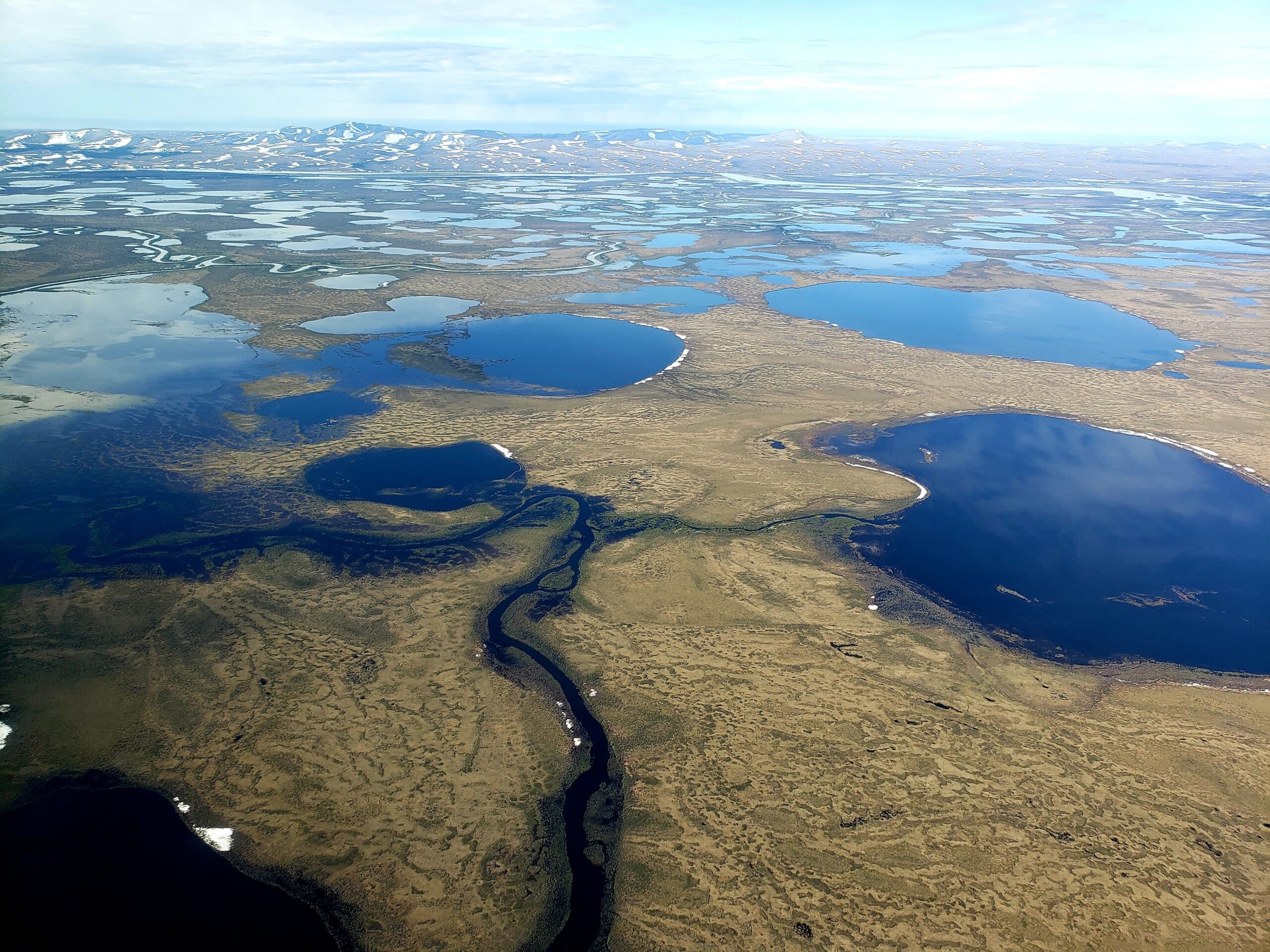 high-angle-view-sea-shore-against-sky-scaled
