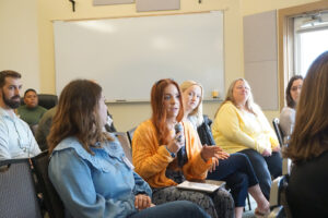 A view of an audience member asking a question to panelists